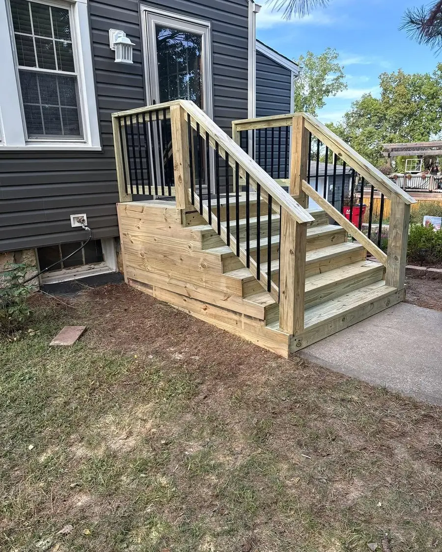 New front stairs with black railings after the repair